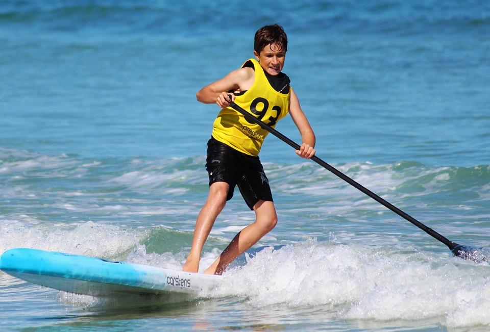 kid renting a stand-up-paddle board